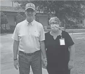  ?? MARY DANIEL ?? Steve and Mary Daniel hold hands outside Rosecastle at Deerwood, a memory-care center where Steve lives and Mary took a job.