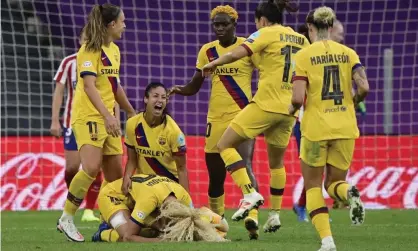 ?? Photograph: Javier Soriano/AP ?? Barcelona’s Kheira Hamraoui (bottom left) celebrates with teammates after scoring the only goal of the match against Atlético Madrid in the Women’s Champions League quarter-final.