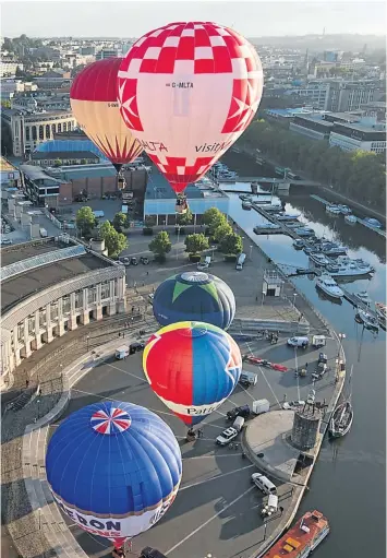  ??  ?? Balloons take to the skies at a preview flight to launch the Internatio­nal Balloon Fiesta in this English city. The four-day event, held this month, is now in its 37th year and is Europe’s largest annual hot-air-balloon event.
The city, beside the...