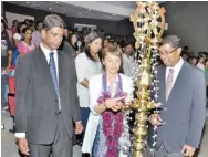  ??  ?? Professor Jenny Hamilton, Director Undergradu­ate Laws Programme- University of London Internatio­nal Programmes lighting the traditiona­l oil lamp with Mr. Saliya Pieris, Senior Lecturer/director CFPS Academy and Mr. Nanda Muruttettu­wegama, Managing...