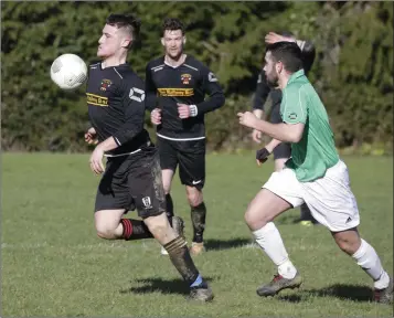  ??  ?? Mark Miley of Avonmore is tracked by Sean Heffernan of Newtown United.