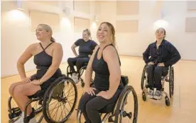  ?? MAGDALENA WOSINSKA/THE NEW YORK TIMES ?? Chelsie Hill, center, with members of the Rollettes, at a rehearsal in June. Hill, who was 17 when she was left with spinal injuries after a car accident, founded the Rollettes, a dance team for women who use wheelchair­s.