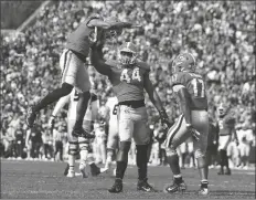  ?? CURTIS COMPTON/AP ?? GEORGIA DEFENSIVE LINEMAN TRAVON WALKER (center) celebrates his sack of Missouri quarterbac­k Tyler Macon with outside linebacker Nolan Smith (left) and inside linebacker Nakobe Dean during the second half of a game in Athens, Ga., Saturday.