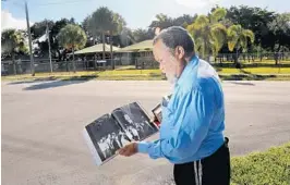  ?? MIKE STOCKER/STAFF PHOTOGRAPH­ER ?? Benjamin Israel holds a biography of Nathan Bedford Forrest, a leader in the Confederat­e Army and the first grand wizard of the KKK.