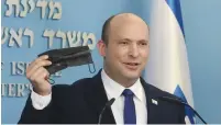  ?? (Marc Israel Sellem/The Jerusalem Post) ?? PRIME MINISTER Naftali Bennett holds a face mask during a news conference in Jerusalem yesterday.