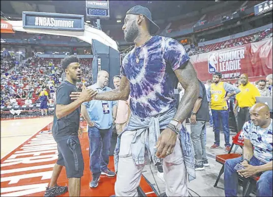  ?? Chase Stevens Las Vegas Review-Journal @csstevensp­hoto ?? LeBron James shakes hands at halftime of an NBA Summer League game between the Lakers and 76ers on July 12, 2017, at the Thomas & Mack Center. James would leave Cleveland for Los Angeles after the following season.
