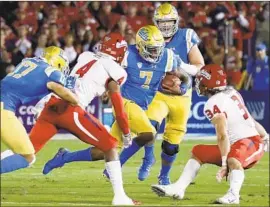  ?? Luis Sinco Los Angeles Times ?? UCLA quarterbac­k Dorian Thompson-Robinson (7), looking for room, completed less than 50% of his passes during losses to Fresno State and Colorado.