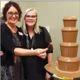  ??  ?? Jennifer LaRose and Monica Giesbrecht of the Heritage Retirement Resort test out the chocolate fountain.