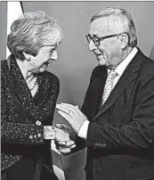  ?? EMMANUEL DUNAND/GETTY-AFP ?? EU’s President Jean-Claude Juncker greets Britain’s Theresa May, who must now sell a Brexit deal to Parliament.