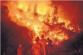  ?? NOAH BERGER/ASSOCIATED PRESS ?? Firefighte­rs monitor a backfire while battling the Ranch Fire, part of the Mendocino Complex Fire near Ladoga, Calif., earlier this month.