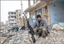  ?? THE ASSOCIATED PRESS ?? Islamic State fighters have vowed to attack Kobani again after their defeat there. Syrian Kurds like the sniper pictured played a part in forcing the militants out of the town.