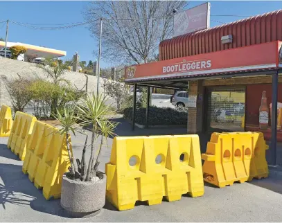  ?? Picture: Neil McCartney ?? SHUTTERED. A closed bottle store in Corlett Gardens after alcohol sales were abruptly stopped by President Cyril Ramaphosa as part of the government’s fight against Covid-19.