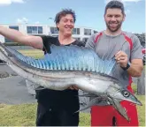  ??  ?? Nik Pyselman and Cameron Twigley with the lancetfish they caught in the shallows at Fitzroy beach, New Plymouth.