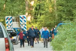  ?? RANDALL K. WOLF/AP ?? Search-and-rescue teams leave the command post Sunday en route to the Blue Ridge Parkway to search for the crash site near Montebello, Virginia.