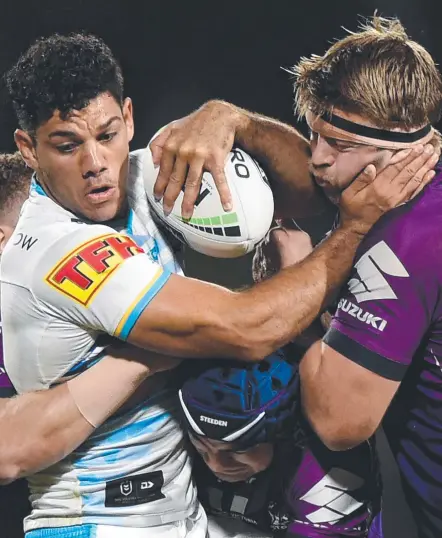  ?? Picture: MATT ROBERTS/GETTY IMAGES ?? Brian Kelly of the Gold Coast Titans is tackled by the Melbourne Storm’s Christian Welch.