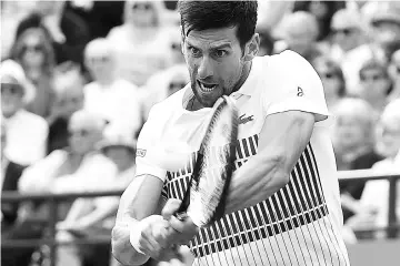  ??  ?? Serbia’s Novak Djokovic plays a shot to Russia’s Daniil Medvedev during their men’s semi-final tennis match at the ATP Aegon Internatio­nal tennis tournament in Eastbourne, southern England, on June 30, 2017. Novak Djokovic beat Daniil Medvedev 6-4,...