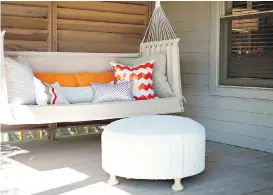  ?? ABBE FENIMORE ?? Left, if a front porch has enough space, comfortabl­e seating like this can create the feeling of an outdoor room. Right, a bold blue door set against crisp white creates a cheerful atmosphere in this front entry area.