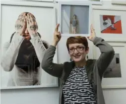  ?? KATHY KMONICEK FOR THE TORONTO STAR ?? Debra Yeo, deputy entertainm­ent editor at the Star, holds her portrait, taken by photograph­er Daphne Chan, at the Ripe Art Gallery in Huntington, N.Y.