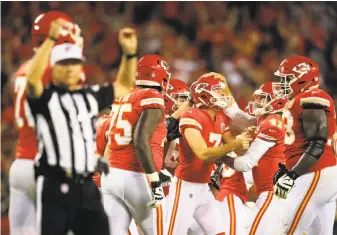  ?? Brian Davidson / Getty Images ?? Harrison Butker (7) of the Chiefs celebrates with teammates after kicking the go-ahead field goal with four seconds left against Washington at Arrowhead Stadium.