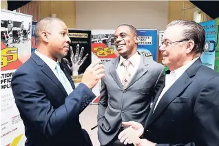  ??  ?? From left: Robin Levy, deputy general manager, Jamaica Stock Exchange (JSE); Jermaine Deans, deputy general manager, JN Fund Managers Ltd; and David McDaniel, chairman and managing director of Stationery & Office Supplies Ltd (SOS) in an animated...