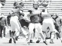  ?? COURTESY PHOTO ?? Virginia quarterbac­k Brennan Armstrong attempts a pass Saturday during the Cavaliers’ spring scrimmage before 5,000 at Scott Stadium.