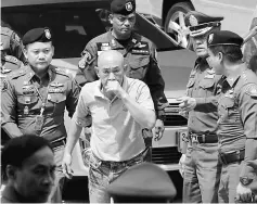  ??  ?? Manmai (centre) arrives at a court in Bangkok, Thailand. — Reuters photo