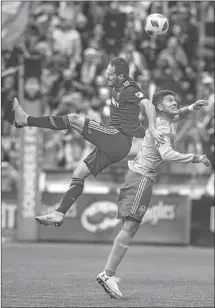  ?? Stephen Brashear Getty Images ?? MARCO URENA of Los Angeles FC and Tony Alfaro of Seattle go up for a header during the first half at CenturyLin­k Field.