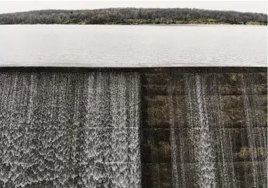  ?? Seth Wenig / Associated Press ?? Water from Lake Welch flows over a dam in Harriman State Park near Stony Point, N.Y. Dozens of dams in the U.S. are upstream from homes, highways or businesses, posing potential threats to people if they fail.