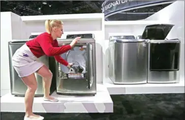  ?? DAVID MCNEW/AFP ?? This file photo taken on January 6, shows an exhibitor demonstrat­ing an Inverter Direct Drive washing machine at the LG exhibit during the 2016 Consumer Electronic­s Show in Las Vegas, Nevada.