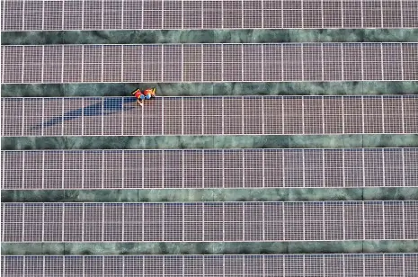  ?? AFP ?? A solar plant in southern China’s Fujian province. Opec has been critical of the IEA over its prediction of peak fossil fuel demand