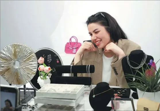  ?? XINHUA ?? A saleswoman promotes accessorie­s from a livestream­ing studio at the Xi’an Internatio­nal Trade and Logistics Park in Xi’an, capital of Shaanxi province, in March.