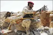  ?? JON GAMBRELL / ASSOCIATED PRESS ?? A Yemeni soldier allied to the country’s internatio­nally recognized government unslings his machine gun on the outskirts of Sanaa, Yemen. More than 10,000 people have been killed in the war.