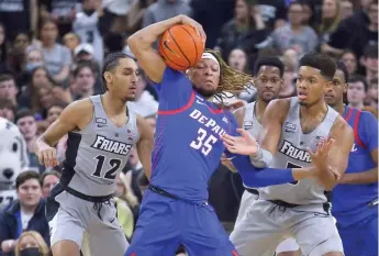  ?? STEW MILNE/AP ?? DePaul’s Brandon Johnson (10 points) battles to keep the ball away from Ed Croswell on Saturday.