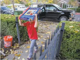  ??  ?? Alex Hickman, age 6, carries a toy into the family’s new Calistoga home. The Hickman family fled just in time to escape the inferno during the Tubbs Fire.