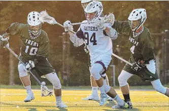  ?? CLIFFORD SKARSTEDT EXAMINER ?? Trent Excalibur's Riley Armstrong (10) picks up a pass intended for Bishops Gaiters' Xavier Perron (94) during men's lacrosse team season opener in Canadian University Field Lacrosse Associatio­n action on Saturday.