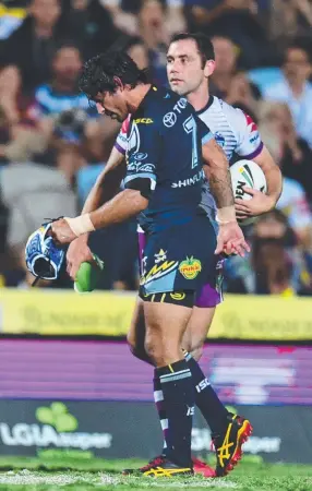  ?? LEGENDS: Johnathan Thurston and Cameron Smith crossing paths last night. ??