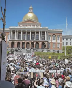  ?? STAFF PHOTO BY NANCY LANE ?? DEMONSTRAT­ION: Protesters gather outside the State House to rally against the policy of separating illegal immigrant families.