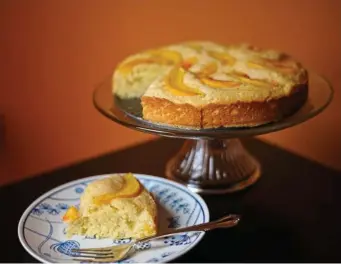  ??  ?? CURDS AND WHEY: Made with homemade ricotta cheese, this peach cake is moist, light and delightful­ly peachy.