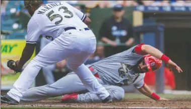  ?? The Associated Press ?? CARPENTER’S WORK: Milwaukee Brewers relief pitcher Jhan Marinez is late with a tag on St. Louis Cardinals’ Matt Carpenter, who scored on a wild pith during the seventh inning Monday in Milwaukee. Carpenter recorded four hits and three runs, leading the...