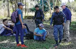  ?? Associated Press file photo ?? An ICE agent, far right, is reportedly training Guatemalan police at a checkpoint where they detain Honduran migrants.