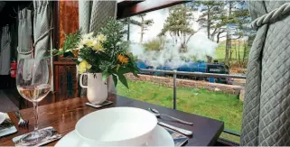  ??  ?? Seen from the window of the superbly-restored Pullman car Maid of Kent, Whillan Beck, the ‘Train From Spain', stands at Ravenglass station. RER