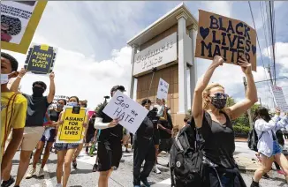  ?? JOHN AMIS / FOR THE AJC ?? Demonstrat­ors leave Gwinnett Place Mall to march down Satellite Boulevard to the Gwinnett police station during a June 7 protest billed as“Justice for Black Lives” in Duluth. Protesters were demonstrat­ing against the deaths of George Floyd and of those whose names never make the headlines.