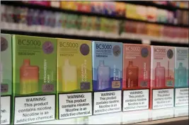  ?? THE ASSOCIATED PRESS ?? Varieties of disposable flavored electronic cigarette devices manufactur­ed by EB Design, formerly known as Elf Bar, are displayed at a store in Pinecrest, Fla., in June.