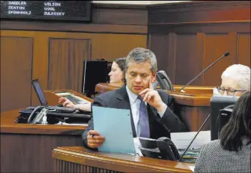  ?? Becky Bohrer The Associated Press file ?? Alaska Rep. Chris Tuck looks over a document in May during a break in the Alaska House floor session. Tuck likes, at least as a starting point, a so-called committee of the whole to run the Alaska House.