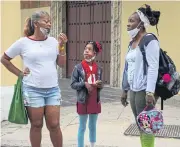  ?? AFP ?? A child and relatives arrive to school in Havana on Wednesday. Cuban authoritie­s announced that schools would close yesterday.