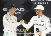  ?? Clive Mason / Getty Images ?? Although they remain bitter rivals, Rosberg (left) and Hamilton were gracious Sunday.