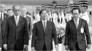  ??  ?? Naruhito (centre) accompanie­d by Razali (right) and Wan Junaidi upon arrival at KL Internatio­nal Airport.— Bernama photo