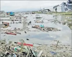  ?? — Reuters photo ?? The ruins of cars as seen after the tsunami hit in Palu.