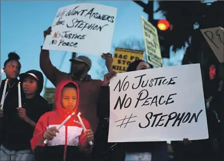  ?? Justin Sullivan Getty Images ?? PROTESTERS gather Friday in Sacramento to denounce police in Sunday’s fatal shooting of Stephon Clark, a 22-year-old black man.