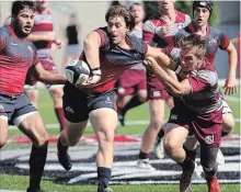  ?? BROCK UNIVERSITY ?? Brock's Zacharias Zorbas is pressured by McMaster to pass the ball in men's rugby.